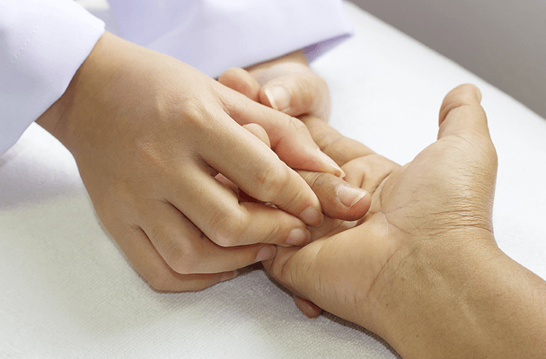 a hand therapist performing therapeutic hand exercises